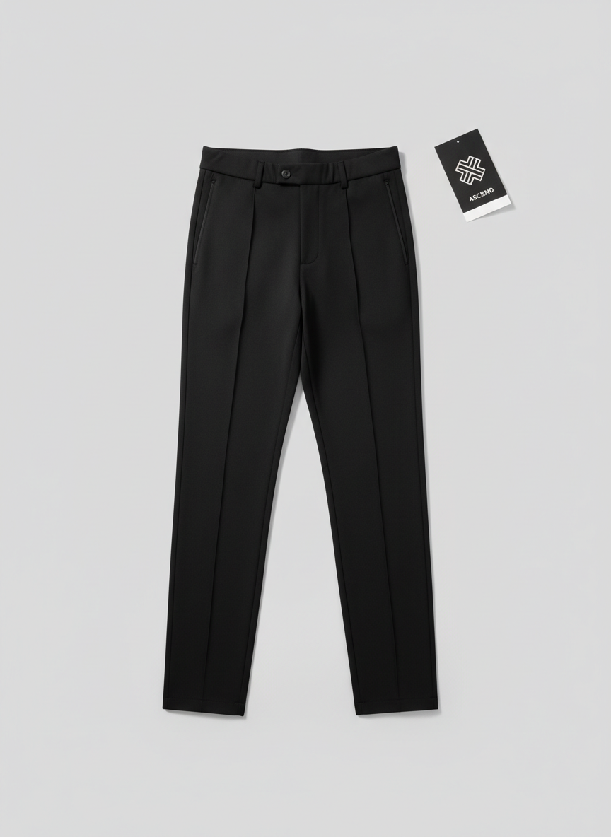 A minimalist product flat-lay designed for a rapid online checkout page: a single unisex, slim-fit black technical track pant with subtle stitched pleats down the front, placed precisely on a seamless light-gray background. The fabric appears smooth yet structured, with a matte finish that resists harsh reflections. At the top-right corner, a small folded tag card with simple monochrome branding hints at premium quality. Soft studio lighting from both sides balances highlights and shadows, revealing the pant’s clean lines, tapered leg, and discreet zip pockets without any distractions. Photographic realism, shot directly from above for a perfectly symmetrical, graphic composition with sharp focus edge to edge. The mood is sleek, efficient, and polished, ideal for a sophisticated sportswear e-commerce environment emphasizing clarity and fast decision-making.